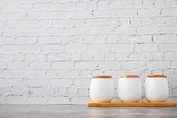 ceramic cups on white brick wall texture backgroun.