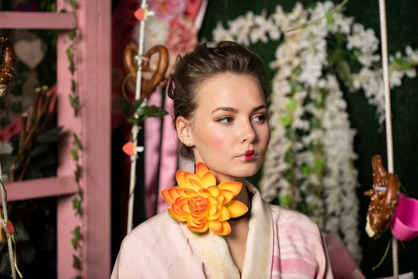 girl in pink japanese kimono on a background of flowers