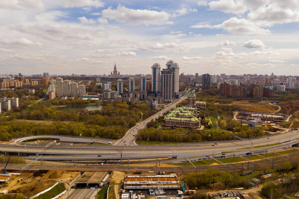 city panoramic view with houses and roads and thunderclouds taken from a quadrocopter