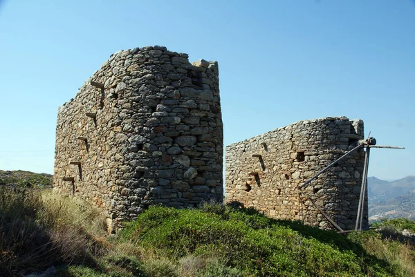the proud ruins of ancient mills by the sea on the island