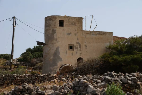 the proud ruins of ancient mills by the sea on the island