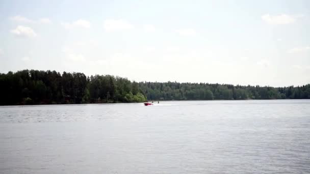 ドローンから撮影された美しい風景を背景に モーターボートが川沿いを移動します — ストック動画