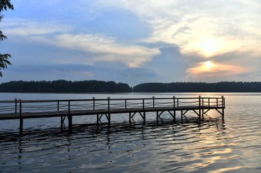 Nehir ormanı ve gökyüzünde fantastik bulutlarla doğal manzara