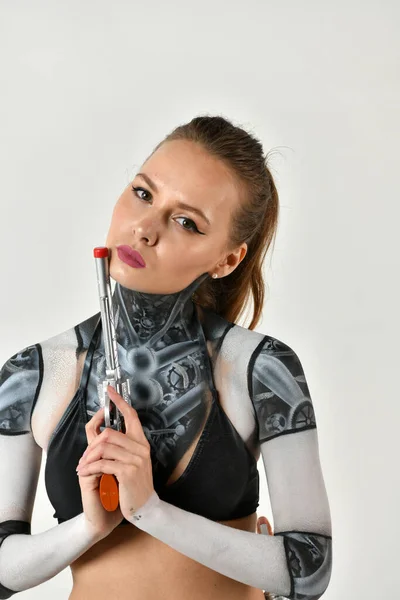 beautiful girl in a robot suit does exercises for martial arts with martial swords