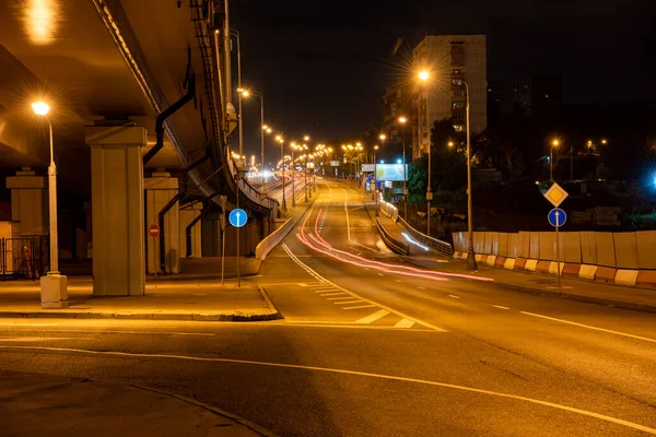 night lights of fast moving cars on the freeway at night