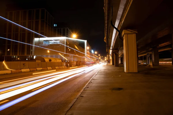 night lights of fast moving cars on the freeway at night