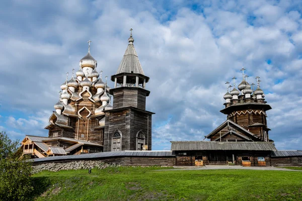 rural landscape with a mill, wooden church and old buildings on the island