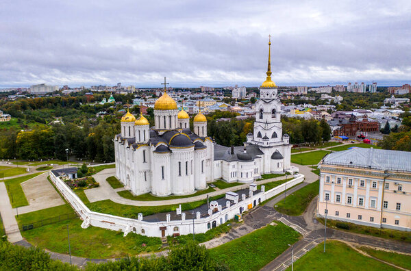 a panoramic view of the old city district with ancient buildings and a church filmed from a drone