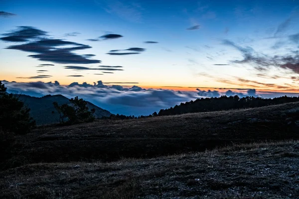 sunrise in the mountains with morning fog from early autumn