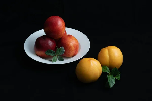 Red Nectarine White Dish Yellow Peach Black Background — Stock Photo, Image