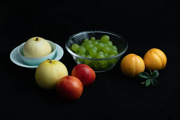 Various fresh fruits on black background