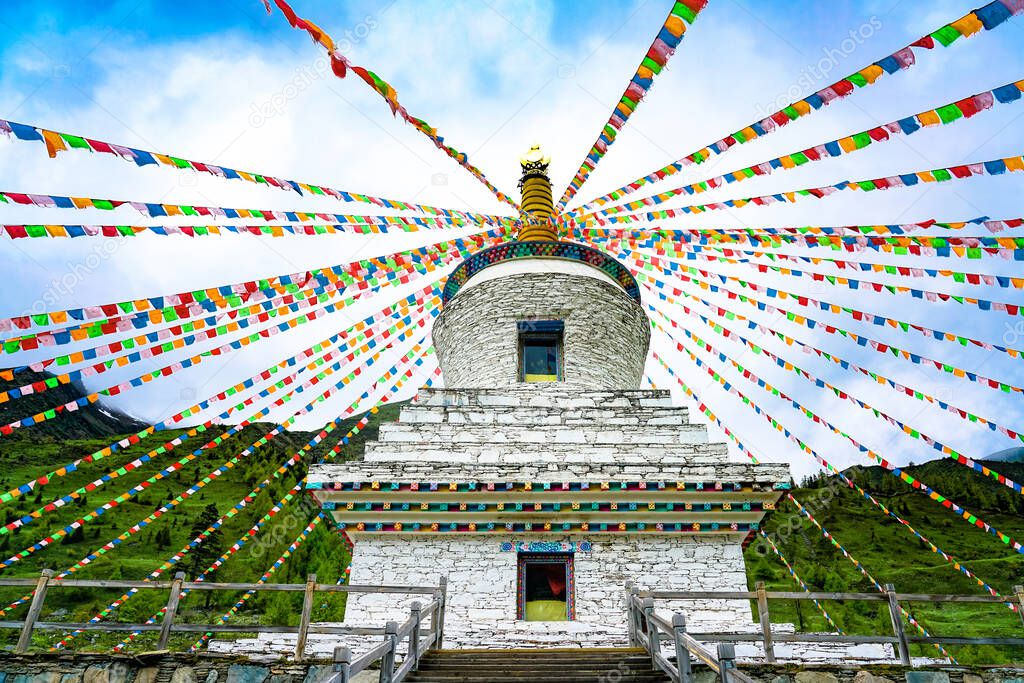 Pagodas and prayers in shuangqiaogou, Siguniangshan, Sichuan Province, China. Tibetan white pagoda prayer flags and Mani Stone