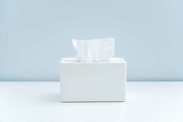 White square napkin box and drawn paper in minimalist home