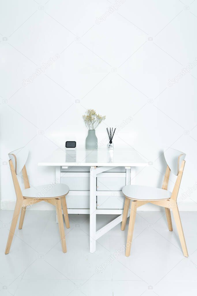 Working at home in a minimalist home. Dining tables and chairs and furnishings in a minimalist modern home. 