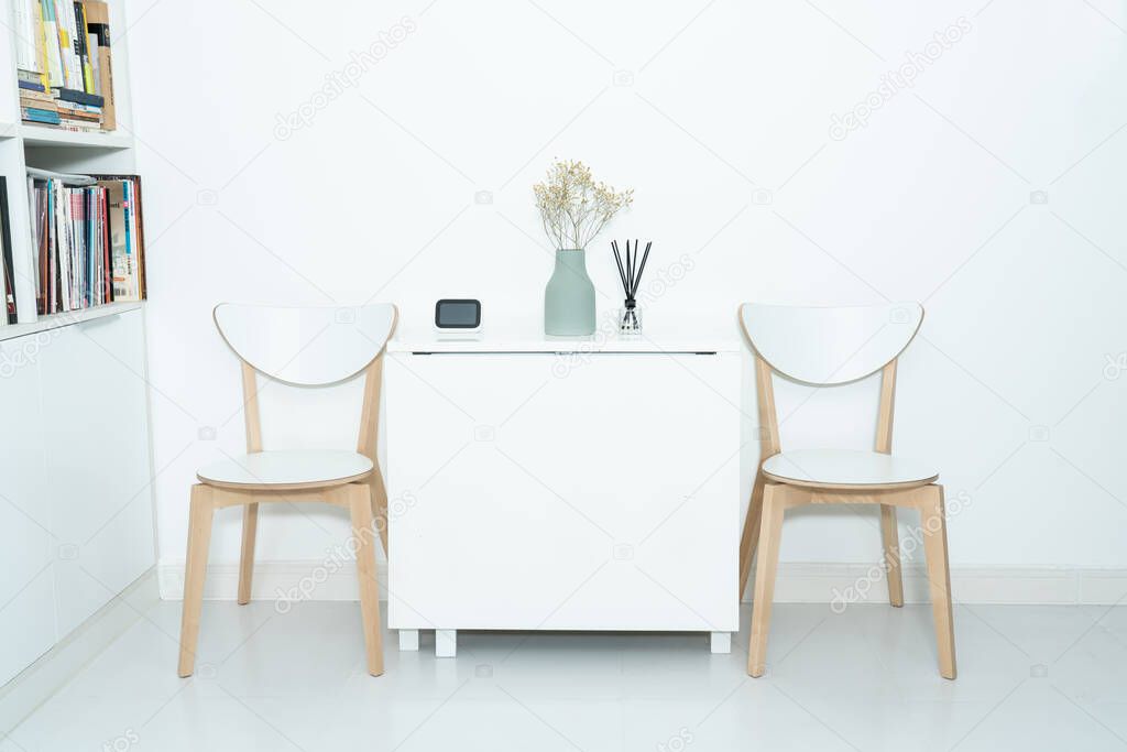 Working at home in a minimalist home. Dining tables and chairs and furnishings in a minimalist modern home. 