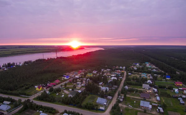 Sunset over the river and houses