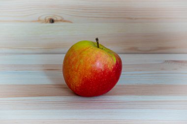 Ahşap masada kırmızı taze elma.