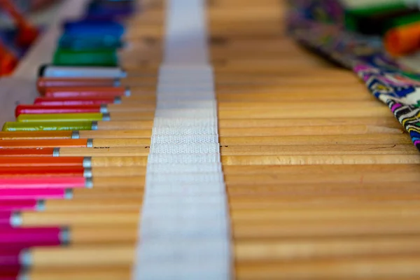 Colored artistic pencils in bag. Colored pencils background.