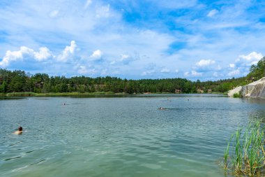 KOROSTYSHIV, UKRAINE - 21 Haziran 2020: Terk edilmiş Korostyshiv taş ocağı, derin mavi suları ve engebeli uçurumlarıyla dinlenme, balık tutma ve yüzme için manzaralı bir yer haline geldi..