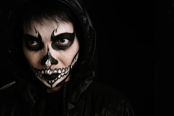 Southeast asian man with skull face makeup and woman on black ba