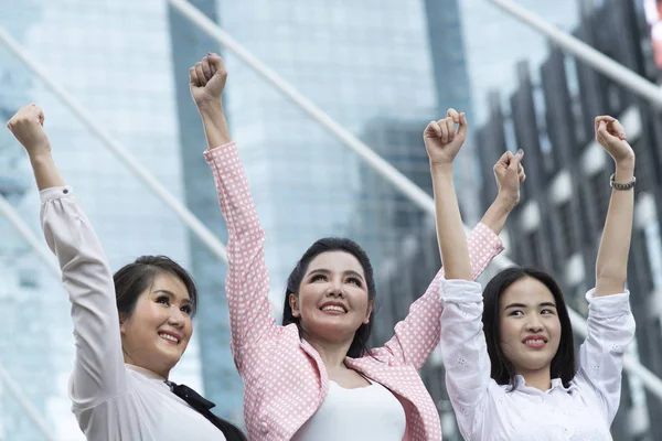 Business women doing self-motivation against building background