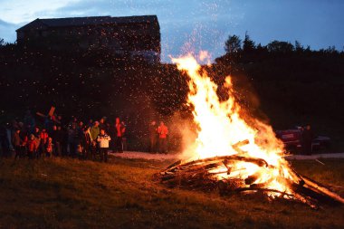 Midsummer fire on the Feuerkogel - When the longest day meets the shortest night, summer is greeted with fires in the Alpine region. The solstice lights are lit around June 21st. clipart