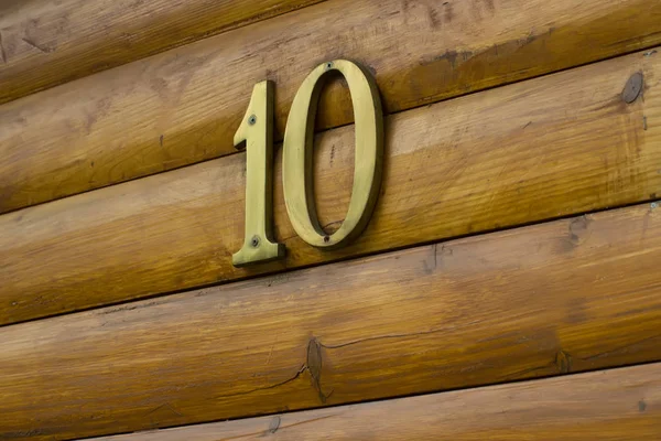 house number ten on a wooden wall