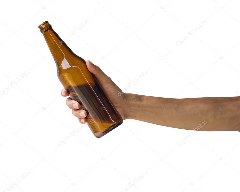 Hand holding beer bottle isolated on white background. Clipping path of transparent brown bottle without label.
