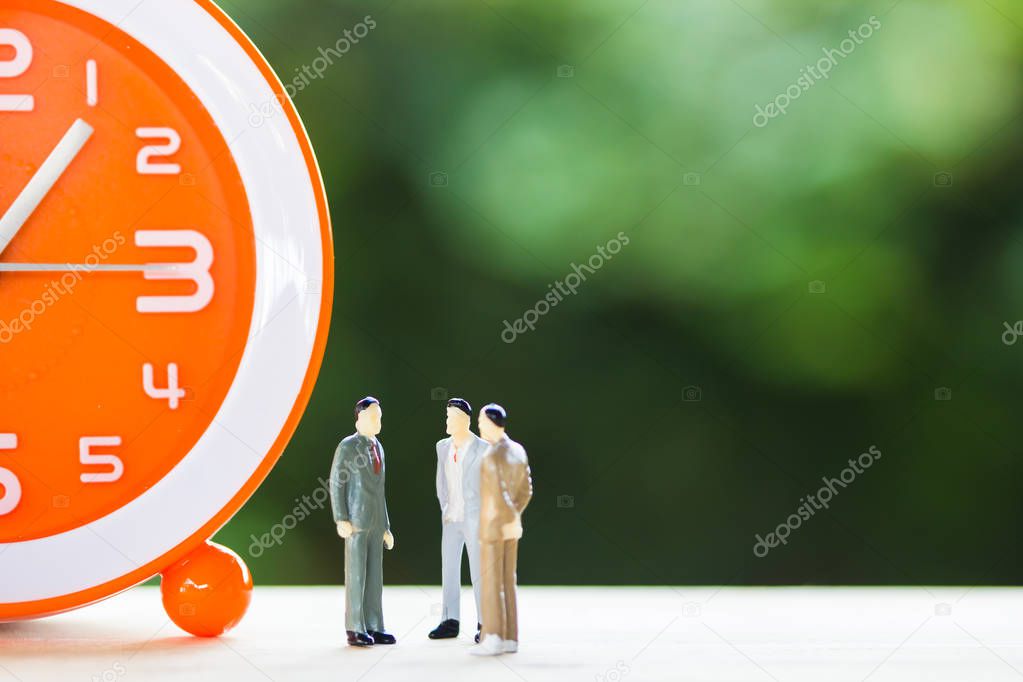 Financial investment negotiation,discussion among CEO or execute level concept: Miniature figurine three businessmen talk on clock time invest contract agreement, discuss about company time in future.