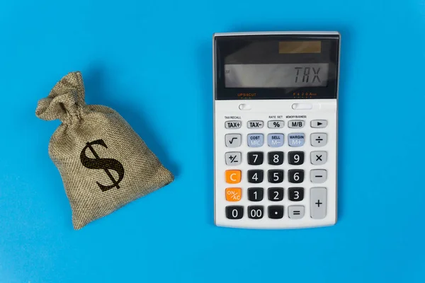 Business and finance taxes concept. A money bag and calculator w