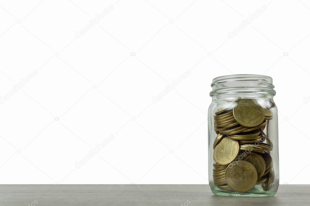 Savings and investment concepts. Stack of coins in a glass jar o