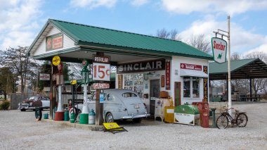 Rural gas station with parked car clipart