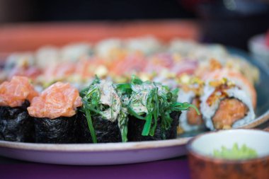 Sushi seti seramik tabak arka plan üzerinde hizmet gıda görüntüsünü kapatın. Metin ve tasarım öğeleri için fotoğraf