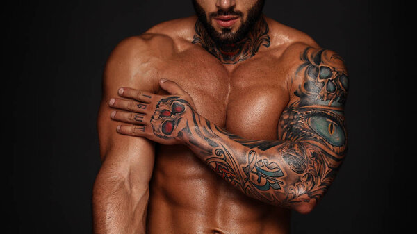 Bodybuilder with muscle torso. Banner image of sexy man with muscular body. Portrait of sexi male model. Hot macho in abs poses on black background. 16 in 9 crop for design