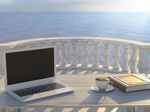 Workplace by the sea. A laptop on a wooden table.
