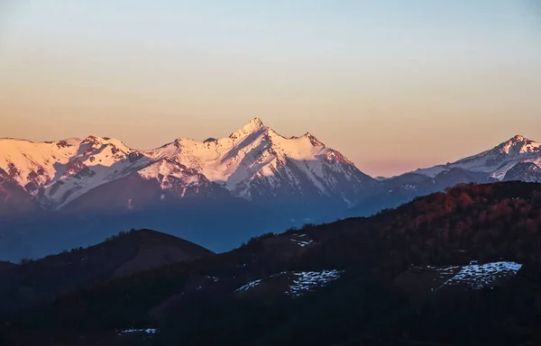 Mountainous landscape of snowy peaks seen from a hill on the other side of the valley in Asturias. Relating to nature, excursions and hiking in northern Spain