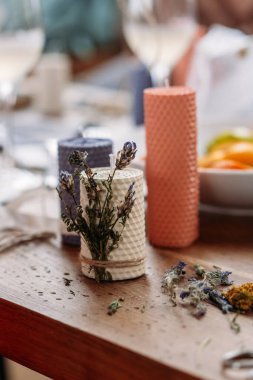 Dekoratif mumlar, makas ve sicim ahşap masada.