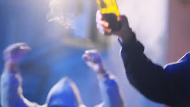 Joven afroamericano con máscara en la cara sosteniendo y lanzando cóctel molotov mientras protestaba entre la multitud desordenada. Manifestante masculino lanzando una botella de fuego en disturbios callejeros. Manifestación agresiva . — Vídeo de stock