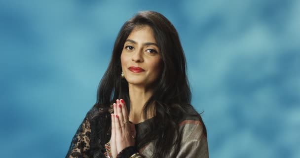 Portrait de la belle femme hindoue élégante en tenue traditionnelle posant et souriant joyeusement à la caméra avec la main tenant comme prier. Namaste concept de salutation. — Video