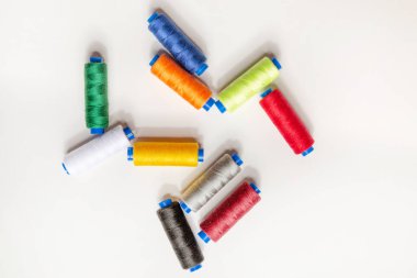 Beyaz arkaplanı dikmek için çok renkli iplikler kümesi