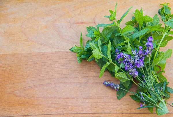 Fragrant garden herbs in a wicker basket, mint, lemon balm, lavender, oregano, basil, thyme, rosemary