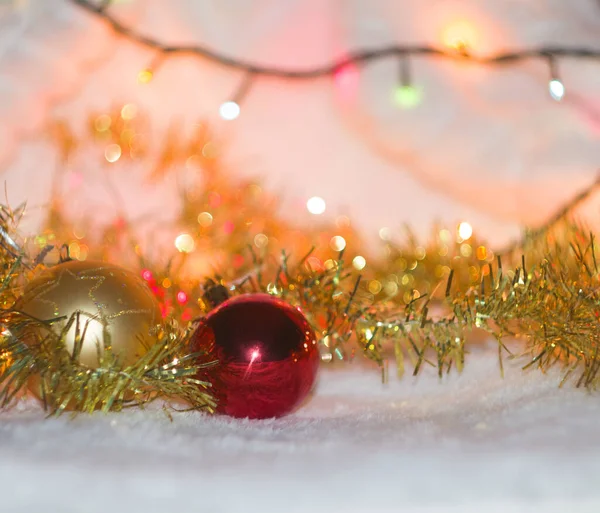 A red and gold balls  on white background with lights and gold decoration, New Year card