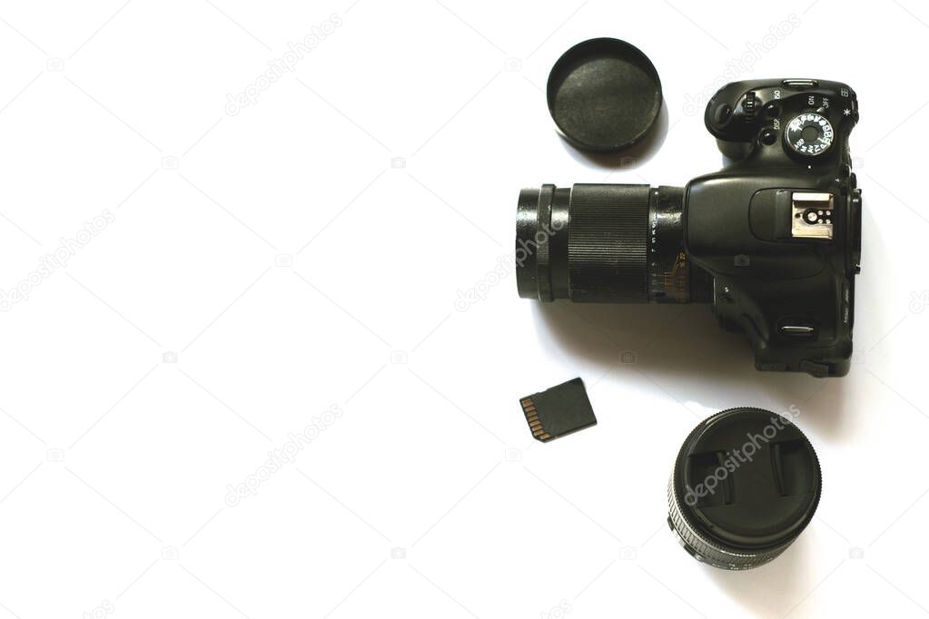 A black camera on the white background, isolated, flat lay