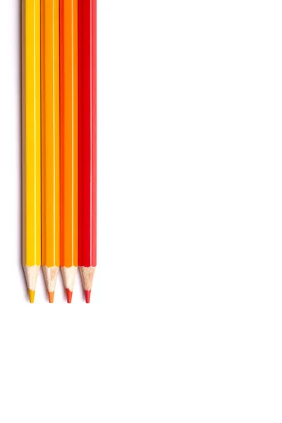Multi-colored wooden pencils in red shades on a white isolated background, autumn colors, mock up, vartically — Stock Photo, Image