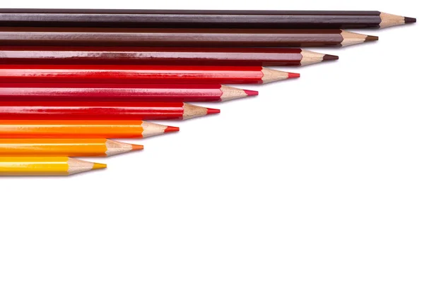 Multi-colored wooden pencils in red shades on a white isolated background, autumn colors, mock up, horizontally — Stock Photo, Image