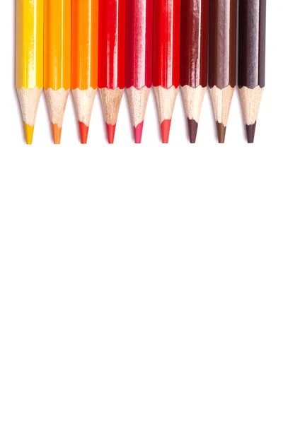 Multi-colored wooden pencils in red shades on a white isolated background, autumn colors, mock up, vertically. — Stock Photo, Image