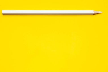 Parlak sarı bir zemin üzerinde yatay beyaz, keskin tahta kalem, izole edilmiş, kopyala uzay, taklit et