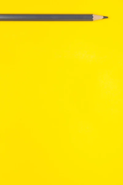 Horizontal gray sharp wooden pencil on a bright yellow background, isolated, copy space, mock up — Stock Photo, Image