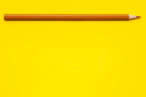 Horizontal light brown sharp wooden pencil on a bright yellow background, isolated, copy space, mock up — Stock Photo, Image