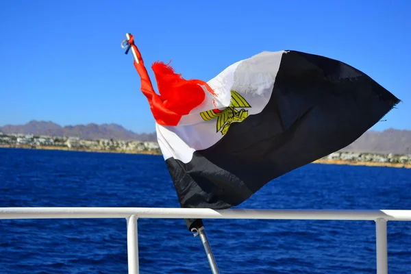 Egyptian flag on the background of the Red Sea. Flag of Egypt on background of sea and Tiran island